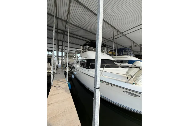 Slide: The Image of 1993 Carver 390 Cockpit Motor Yacht docked in a covered marina. - 3