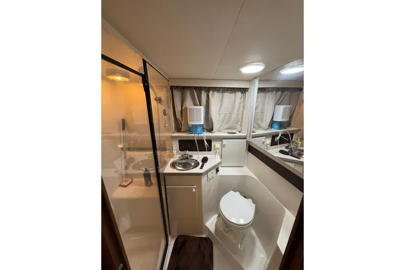 Slide: The Image of Bathroom interior of 1993 Carver 390 Cockpit Motor Yacht, featuring shower and sink. - 30