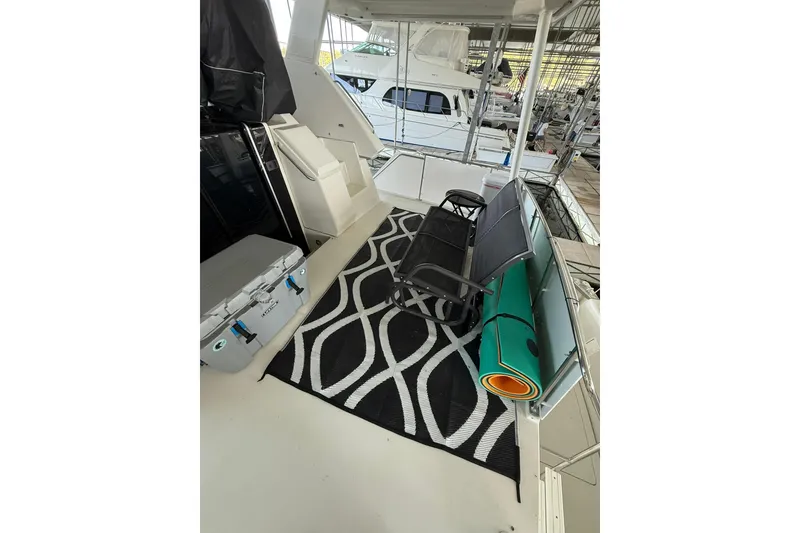 Slide: The Image of 1993 Carver 390 Cockpit Motor Yacht interior with seating, rug, and cooler. - 10