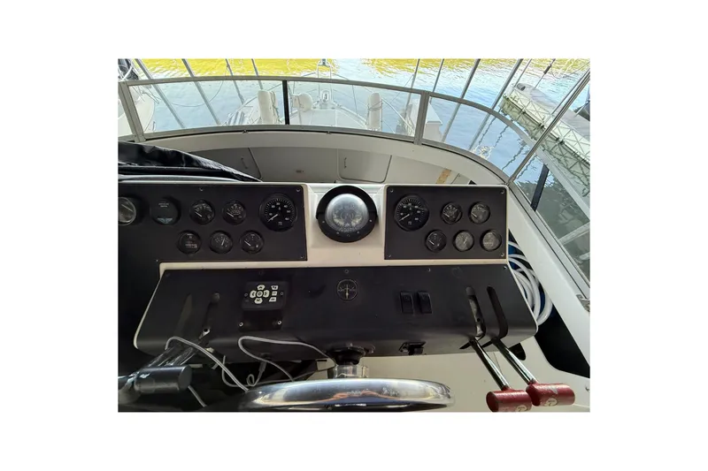 Slide: The Image of 1993 Carver 390 Cockpit Motor Yacht helm with gauges and controls. - 14