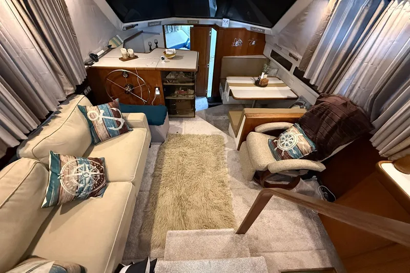 Slide: The Image of Interior of 1993 Carver 390 Cockpit Motor Yacht with cozy seating and nautical decor. - 20