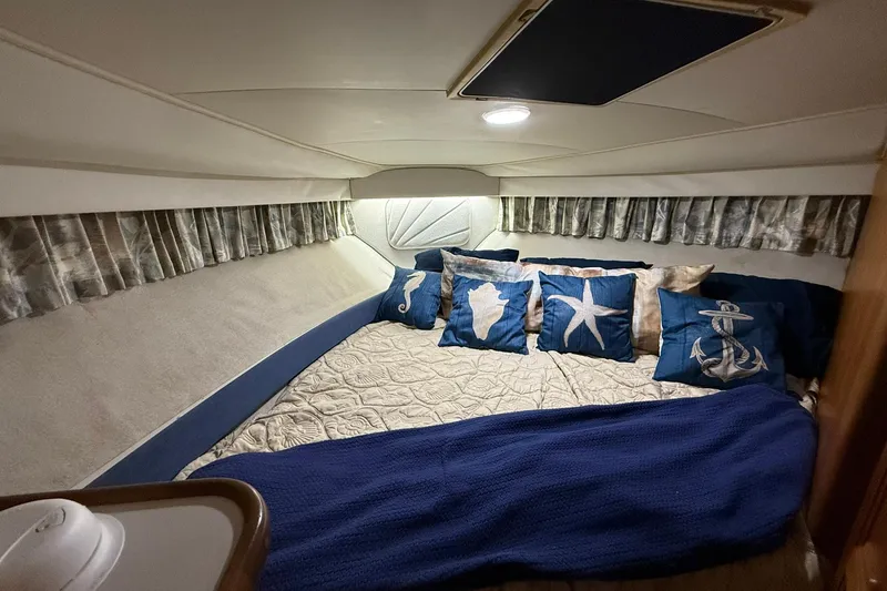 Slide: The Image of Cozy cabin interior of 1993 Carver 390 Cockpit Motor Yacht with nautical-themed pillows. - 24