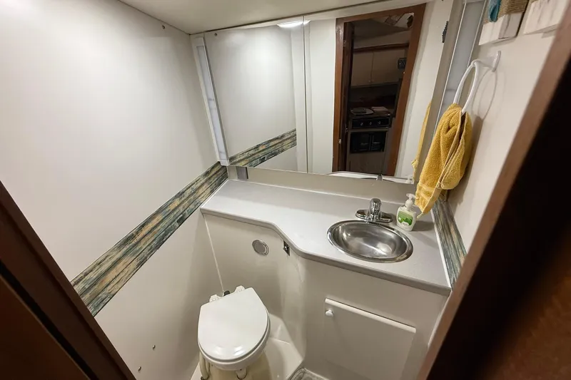 Slide: The Image of Bathroom interior of 1993 Carver 390 Cockpit Motor Yacht with sink and toilet. - 25