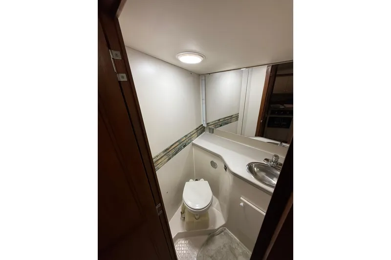 Slide: The Image of Bathroom interior of 1993 Carver 390 Cockpit Motor Yacht with sink and toilet. - 26
