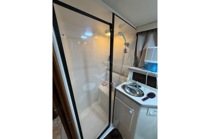Slide: The Image of Interior of 1993 Carver 390 Cockpit Motor Yacht bathroom with shower and sink. - 29