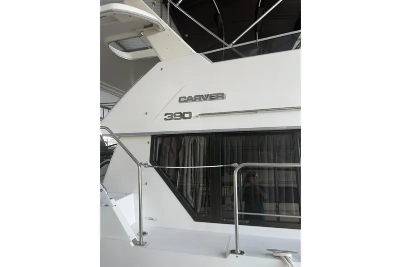Slide: The Image of 1993 Carver 390 Cockpit Motor Yacht, side view with window and railing. - 4