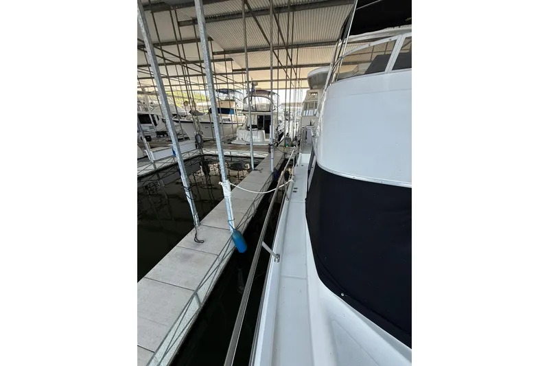 Slide: The Image of 1993 Carver 390 Cockpit Motor Yacht docked in a covered marina. - 6
