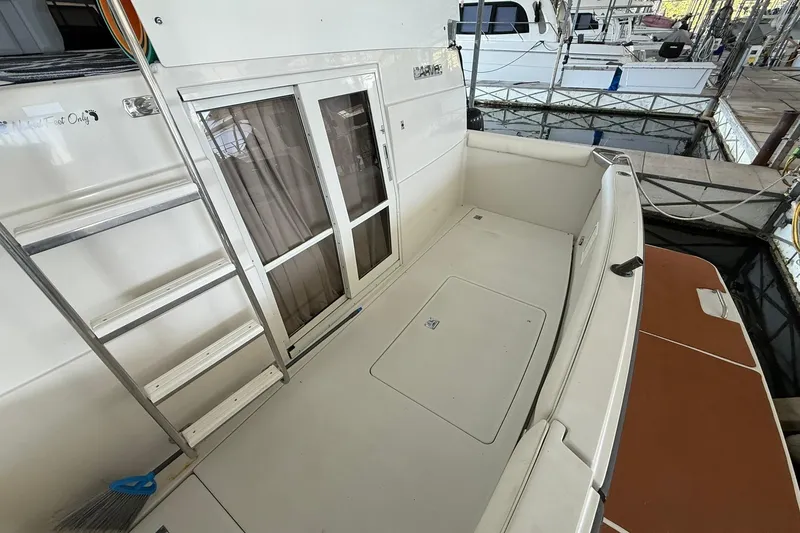 Slide: The Image of 1993 Carver 390 Cockpit Motor Yacht with spacious deck and sliding glass doors. - 7