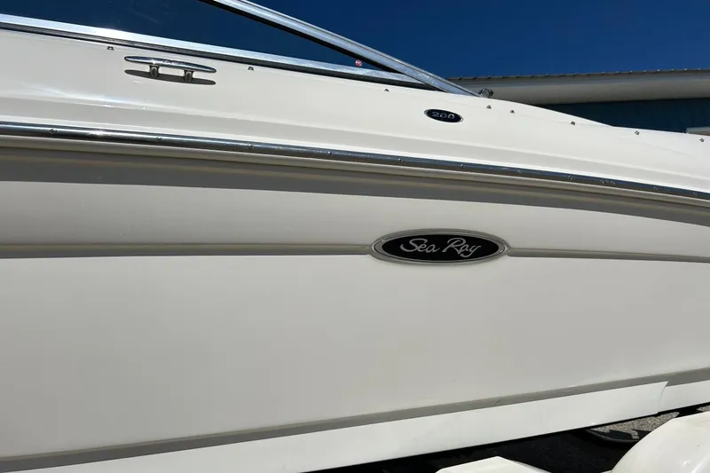 Slide: The Image of 2005 Sea Ray 200 Sport boat side view with logo and chrome details. - 12