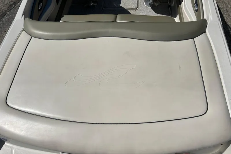 Slide: The Image of 2005 Sea Ray 200 Sport boat with cushioned seating and embossed logo. - 14