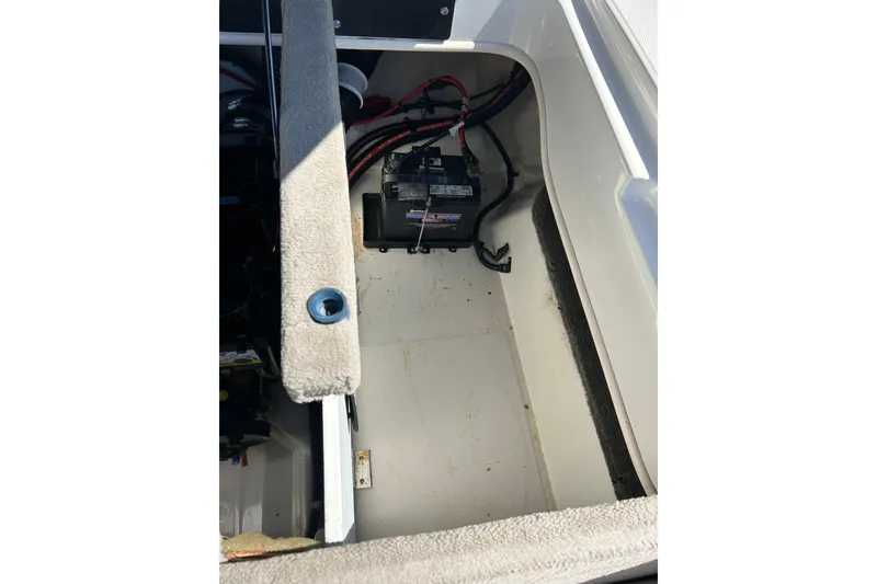 Slide: The Image of 2005 Sea Ray 200 Sport boat battery compartment with visible wiring. - 17