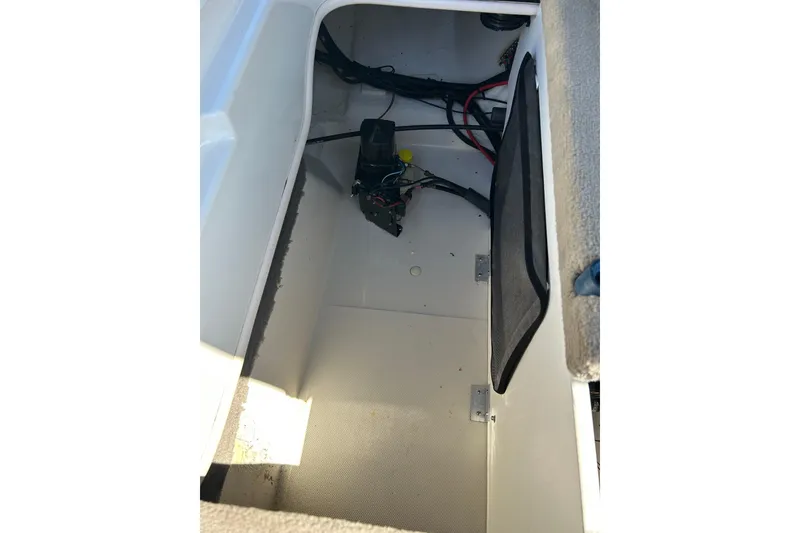 Slide: The Image of Storage compartment of a 2005 Sea Ray 200 Sport boat, showing wiring and interior details. - 18