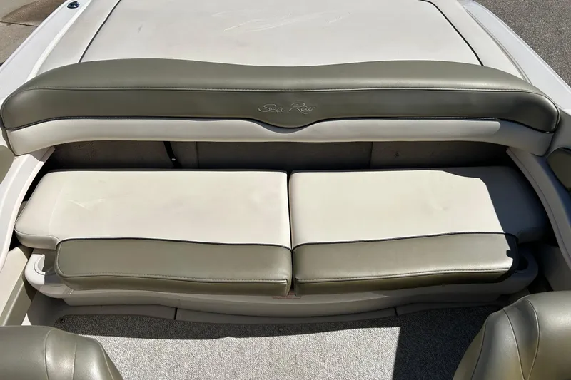 Slide: The Image of 2005 Sea Ray 200 Sport boat interior seating with beige and olive upholstery. - 19