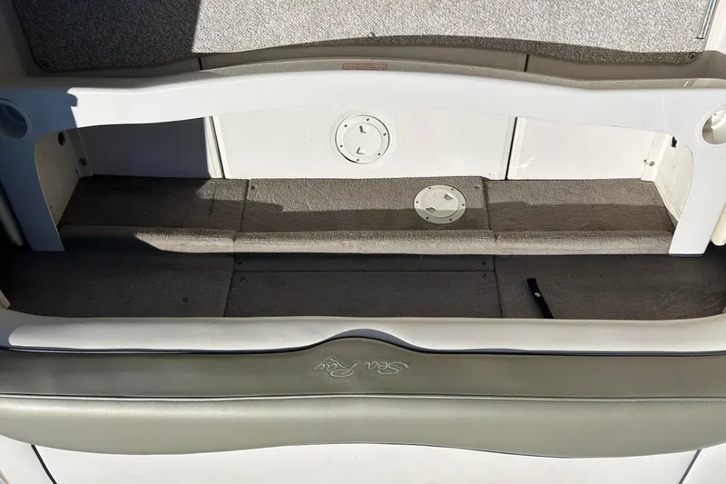 Slide: The Image of 2005 Sea Ray 200 Sport boat interior, featuring storage compartment and seating area. - 20