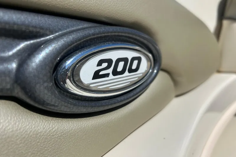 Slide: The Image of Close-up of 2005 Sea Ray 200 Sport emblem on beige interior. - 21