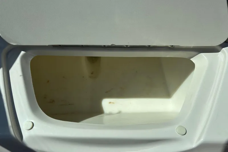 Slide: The Image of Open storage compartment on a 2005 Sea Ray 200 Sport boat. - 26