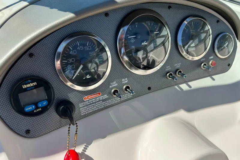 Slide: The Image of Dashboard of a 2005 Sea Ray 200 Sport boat with gauges and controls. - 28