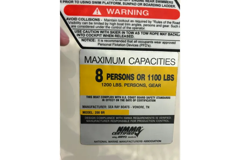 Slide: The Image of Warning label on 2005 Sea Ray 200 Sport, maximum capacity 8 persons or 1100 lbs. - 29