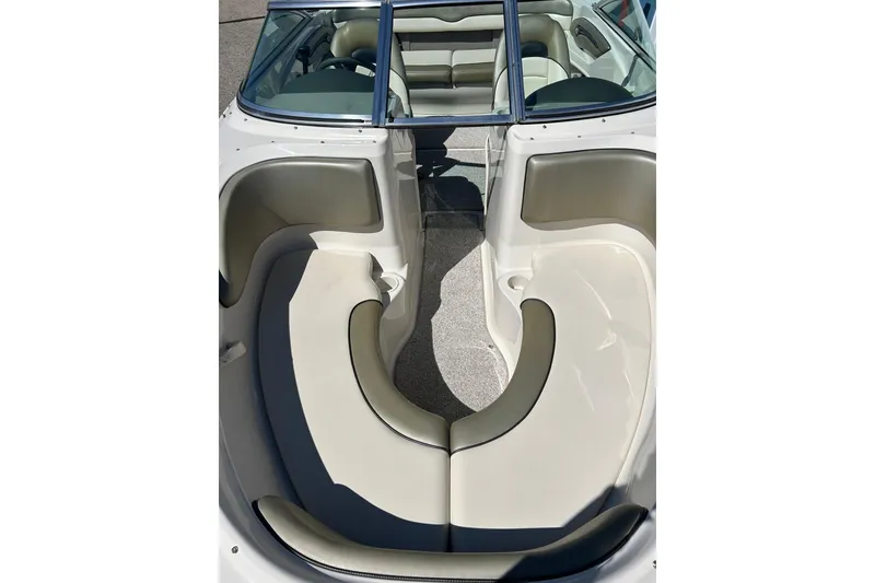 Slide: The Image of 2005 Sea Ray 200 Sport boat interior with beige seating and open bow design. - 3