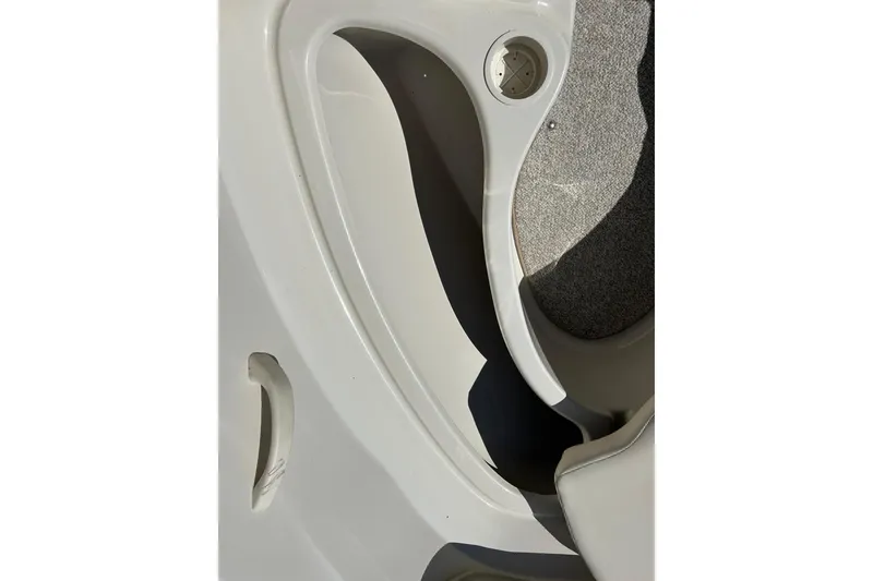 Slide: The Image of 2005 Sea Ray 200 Sport boat interior with cup holder and textured flooring. - 32