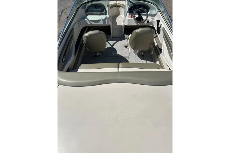 Slide: The Image of 2005 Sea Ray 200 Sport boat interior with beige seating and steering console. - 37