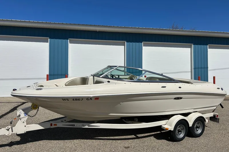 Slide: The Image of 2005 Sea Ray 200 Sport boat on trailer, parked outside blue building. - 39
