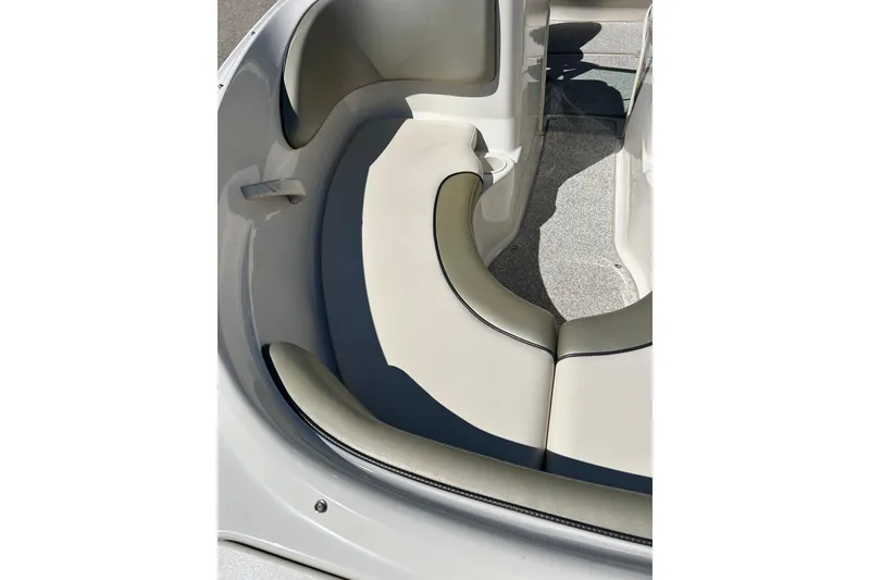 Slide: The Image of 2005 Sea Ray 200 Sport boat interior with beige seating and sleek design. - 4