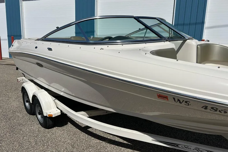 Slide: The Image of 2005 Sea Ray 200 Sport boat on trailer, parked outdoors. - 9