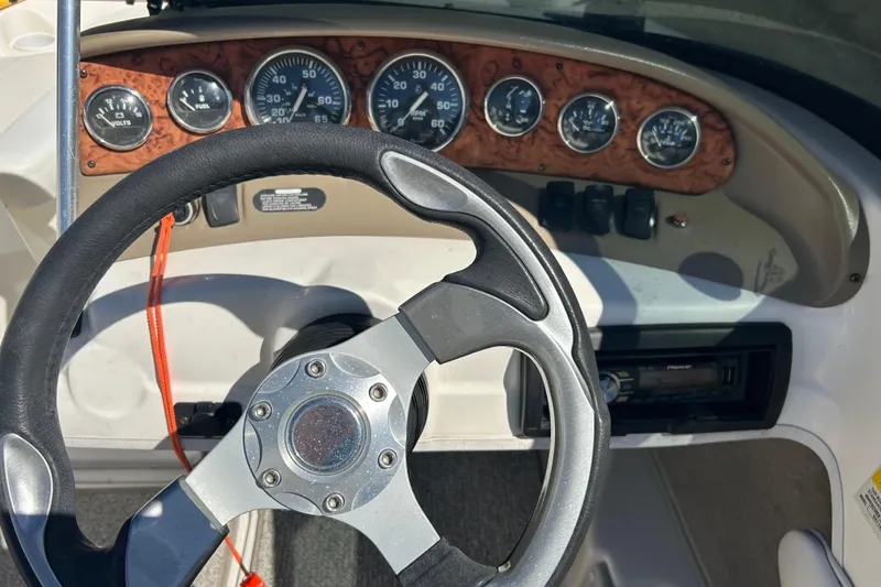 Slide: The Image of Dashboard of a 2007 Larson SEi 180 LX I/O boat with steering wheel and gauges. - 7