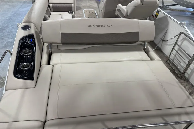 Slide: The Image of 2018 Bennington S 25 boat interior with beige seating and cup holders. - 16