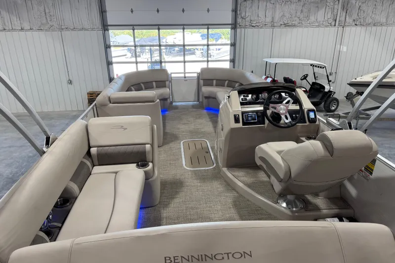 Slide: The Image of 2018 Bennington S 25 pontoon boat interior with plush seating and modern dashboard. - 17
