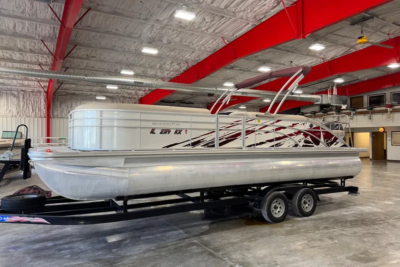 Slide: The Image of 2018 Bennington S 25 pontoon boat interior with plush seating and modern dashboard. - 9