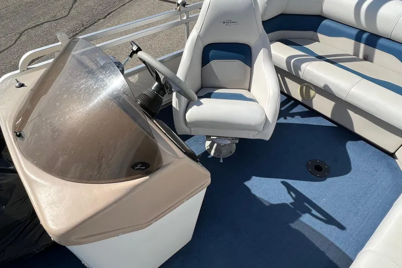 Slide: The Image of 2003 Sylvan 824 Mirage Cruise boat interior with steering console and seating. - 13