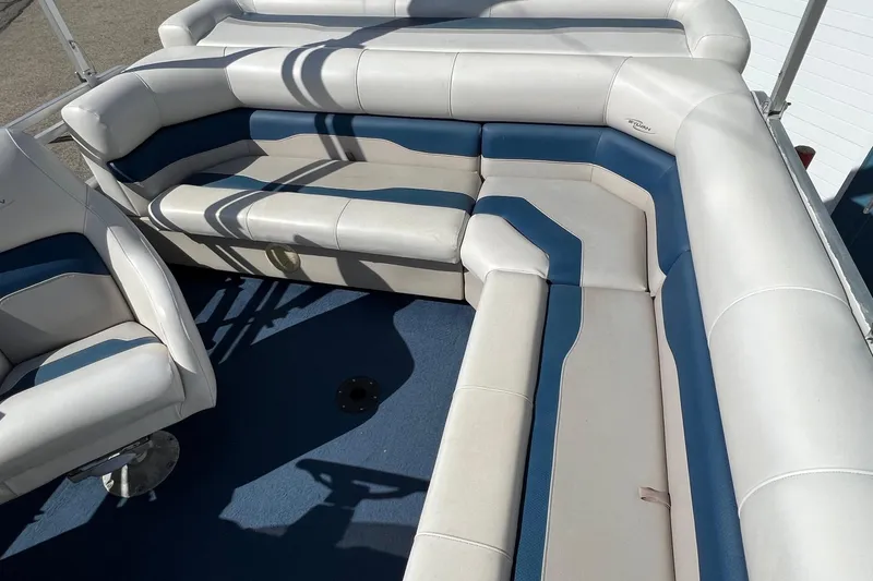 Slide: The Image of 2003 Sylvan 824 Mirage Cruise boat interior with blue and white seating. - 14