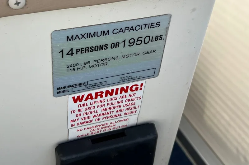 Slide: The Image of 2003 Sylvan 824 Mirage Cruise capacity label, 14 persons or 1950 lbs, with warning notice. - 15