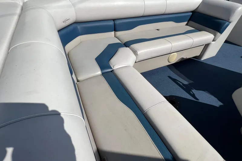 Slide: The Image of 2003 Sylvan 824 Mirage Cruise boat interior with white and blue seating. - 16