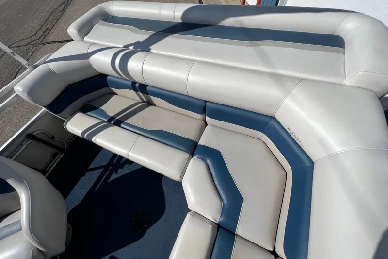 Slide: The Image of 2003 Sylvan 824 Mirage Cruise boat seating with blue and white upholstery. - 18