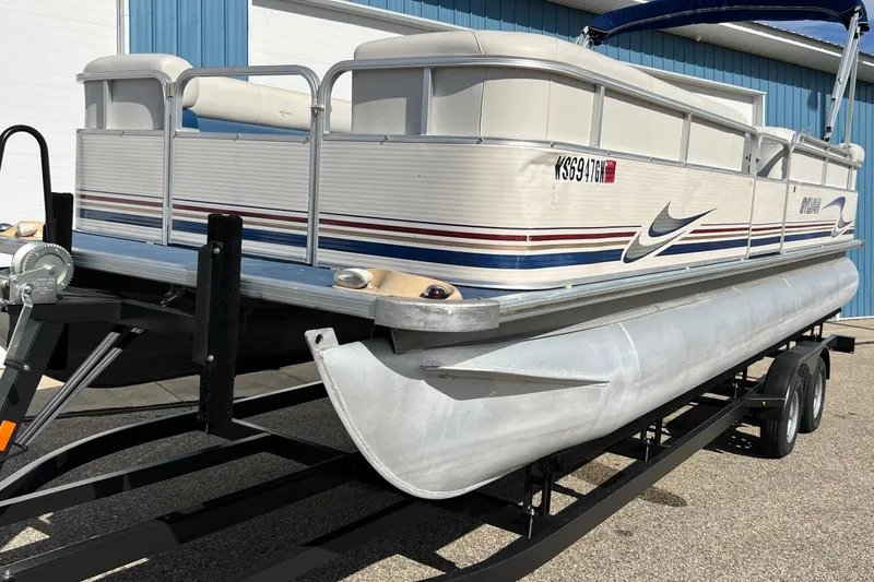 Slide: The Image of 2003 Sylvan 824 Mirage Cruise pontoon boat on trailer, parked outdoors. - 20