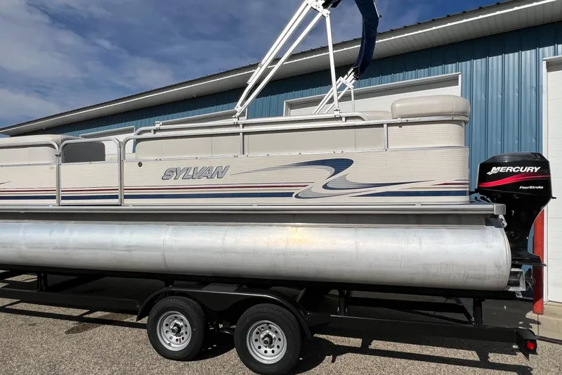 Slide: The Image of 2003 Sylvan 824 Mirage Cruise pontoon boat with Mercury outboard motor on trailer. - 22