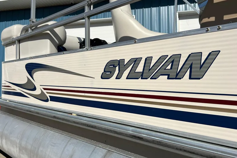 Slide: The Image of 2003 Sylvan 824 Mirage Cruise pontoon boat with sleek design and logo. - 7