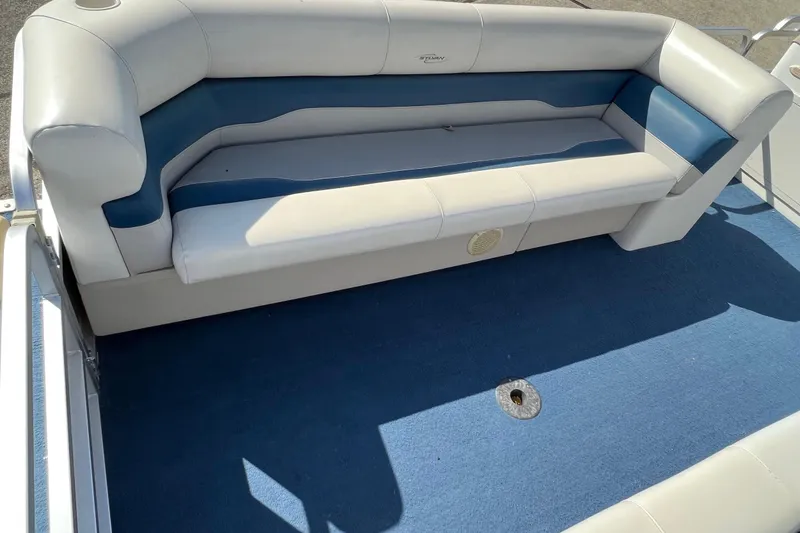 Slide: The Image of 2003 Sylvan 824 Mirage Cruise boat interior with blue and white seating. - 8