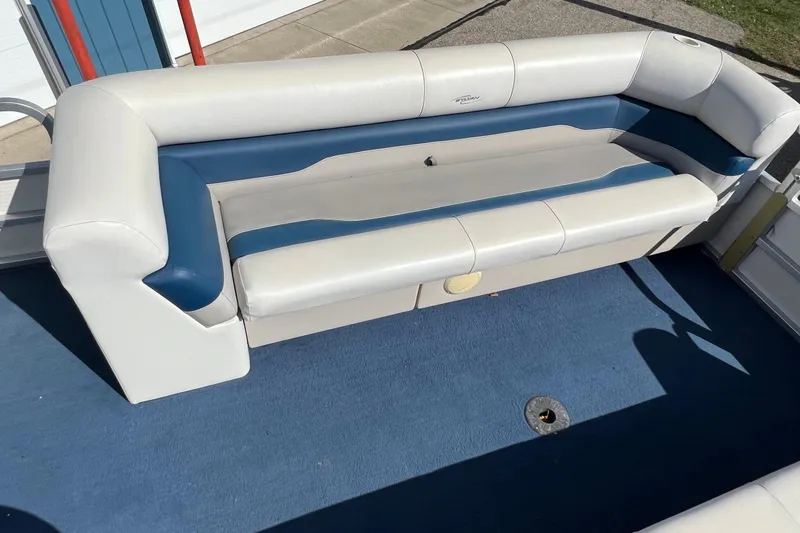 Slide: The Image of 2003 Sylvan 824 Mirage Cruise boat interior with blue and white seating. - 9