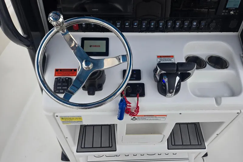 Slide: The Image of Control panel of a 2021 Sea Hunt Gamefish 25 boat with Yamaha steering and controls. - 12