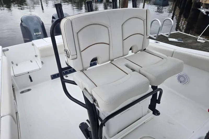 Slide: The Image of 2021 Sea Hunt Gamefish 25 boat interior with dual seats and outboard motor. - 17