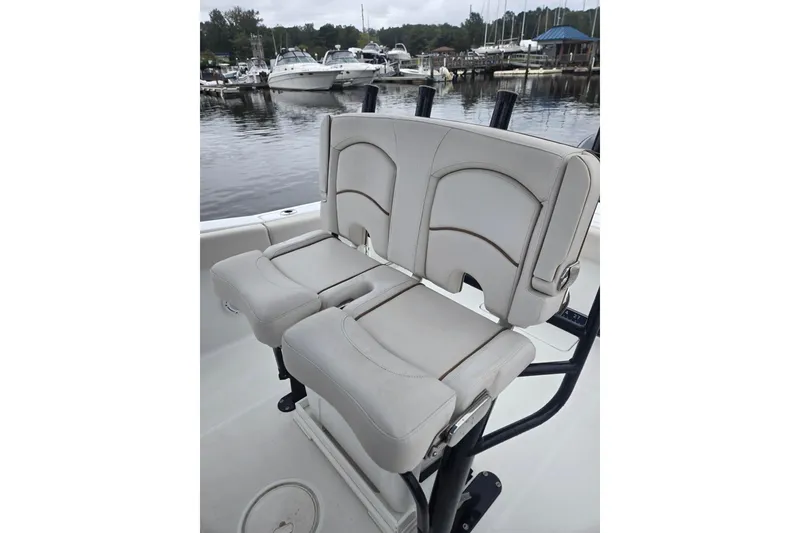 Slide: The Image of 2021 Sea Hunt Gamefish 25 boat seating at marina, featuring comfortable dual seats. - 18