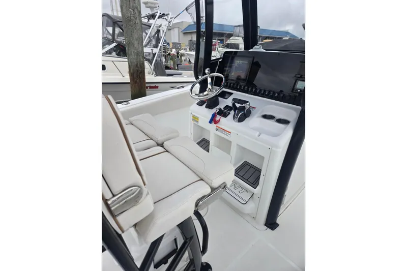 Slide: The Image of 2021 Sea Hunt Gamefish 25 boat cockpit with steering wheel and controls. - 19