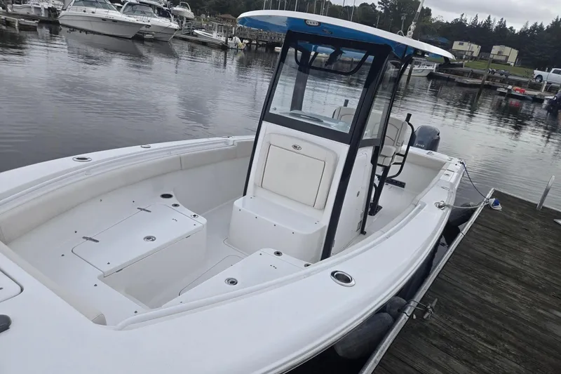 Slide: The Image of 2021 Sea Hunt Gamefish 25 boat docked at a marina, featuring a spacious deck. - 20