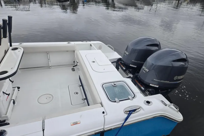 Slide: The Image of 2021 Sea Hunt Gamefish 25 boat with dual Yamaha 150 engines on calm water. - 21