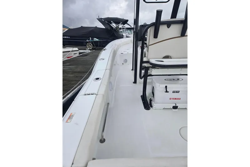 Slide: The Image of 2021 Sea Hunt Gamefish 25 boat interior with Yeti cooler and Yamaha branding. - 24