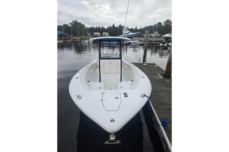 Slide: The Image of 2021 Sea Hunt Gamefish 25 boat docked at a marina, overcast sky. - 5